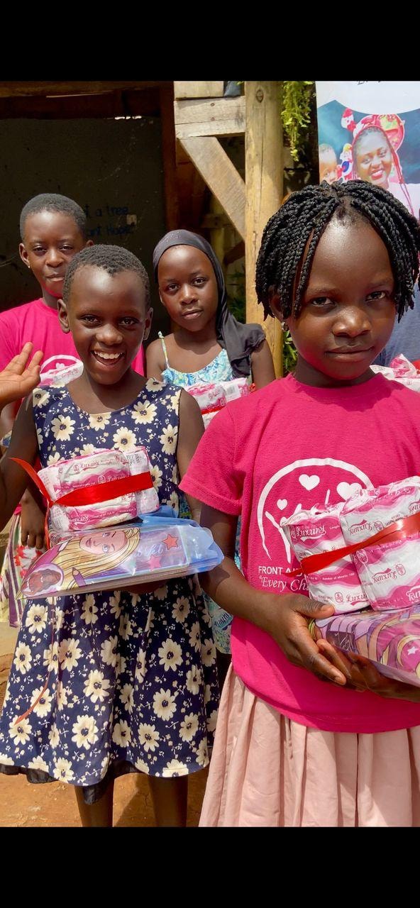Children holding hygiene supplies and books