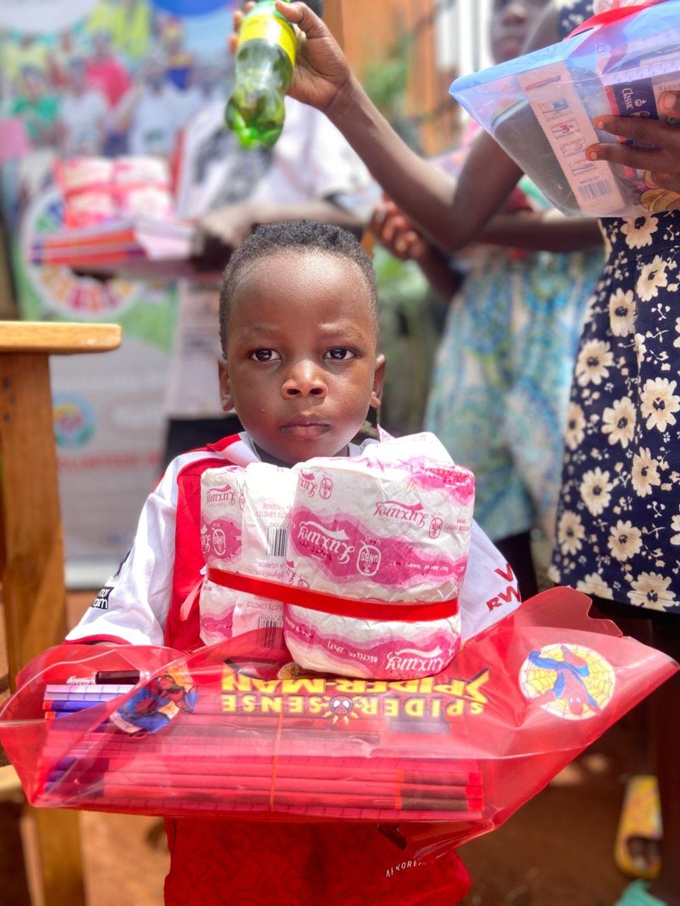 Child holding a school-supplies donation package