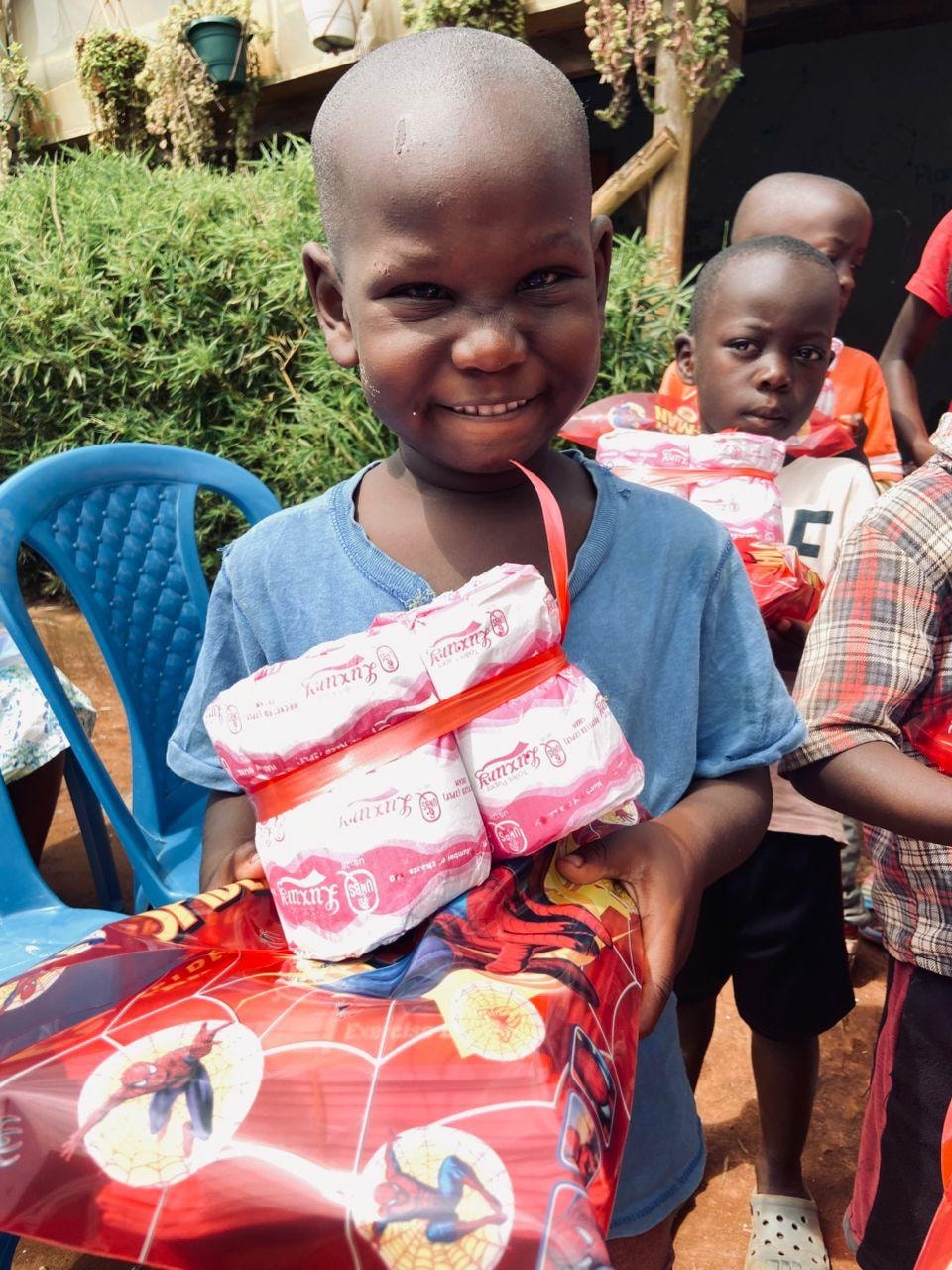 Smiling child holding donated supplies