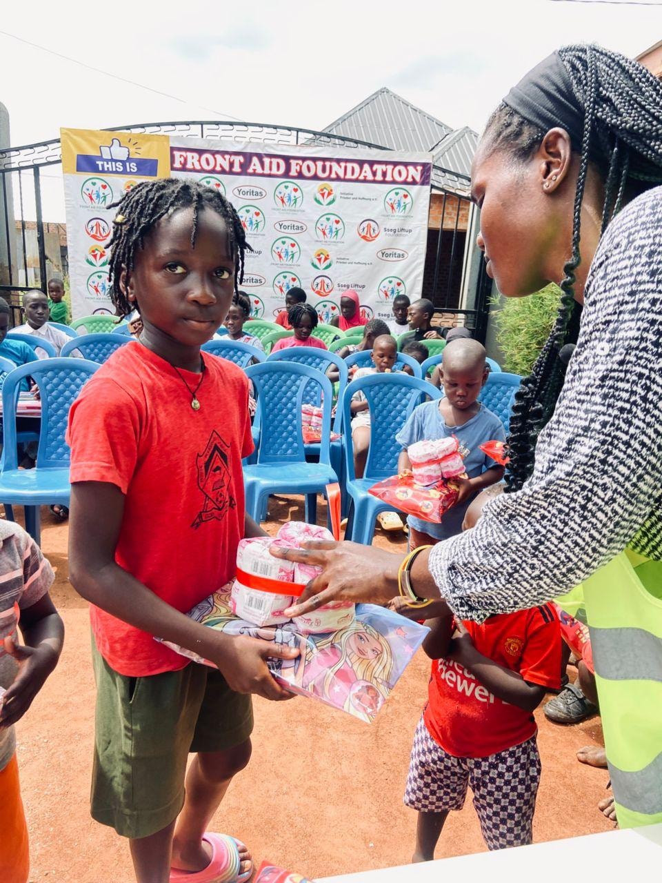 Children receiving donated food supplies at a community event