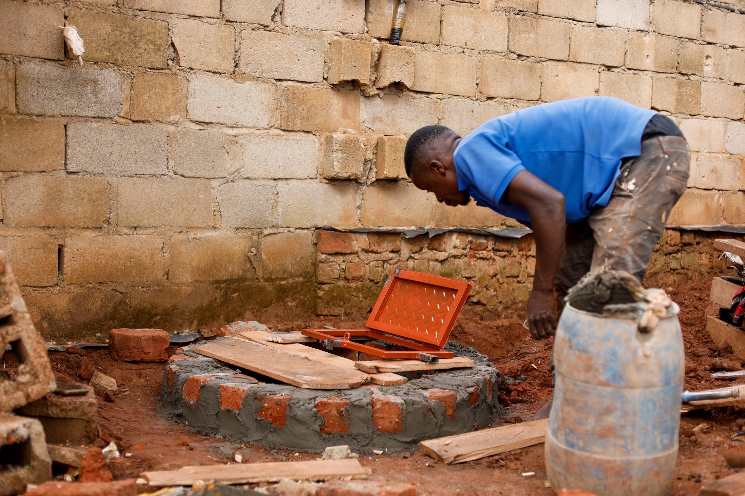 Builders working with bricks at the Buwambo well site