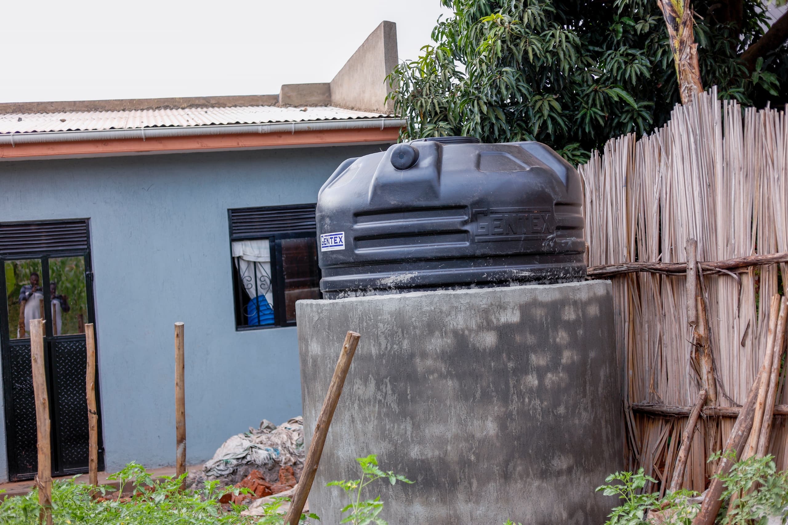 Black water tank beside the Buwambo well project